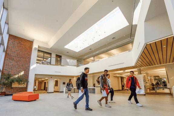 Students walking across the lobby of William Knox Holt Library.